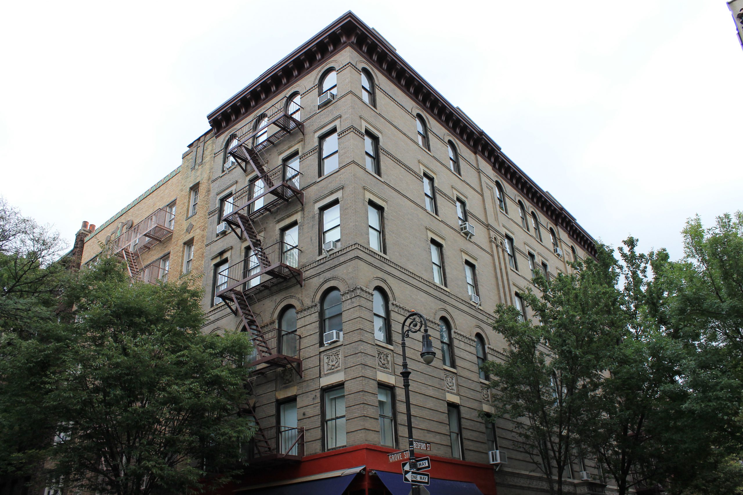 The friends apartment building is on the corner of the Bedford and Grove  streets in Greenwich village